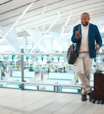 Business traveler holding suitcase at airport