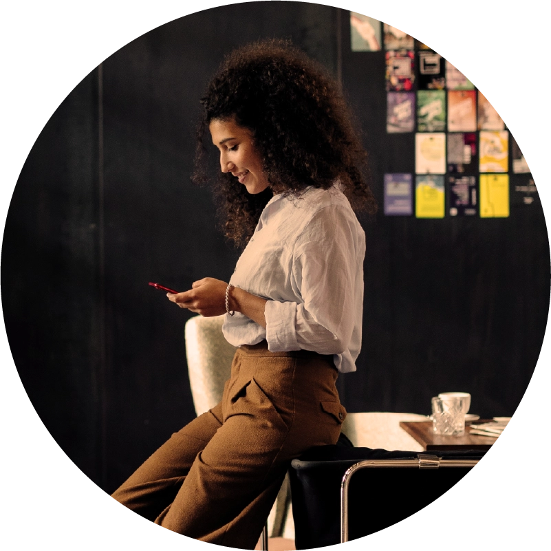 Woman on phone leaning against table