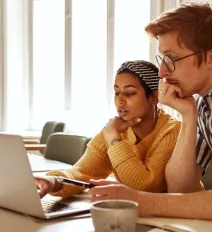 Man and woman working on computer teaser