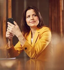 Woman in yellow blazer on cell phone