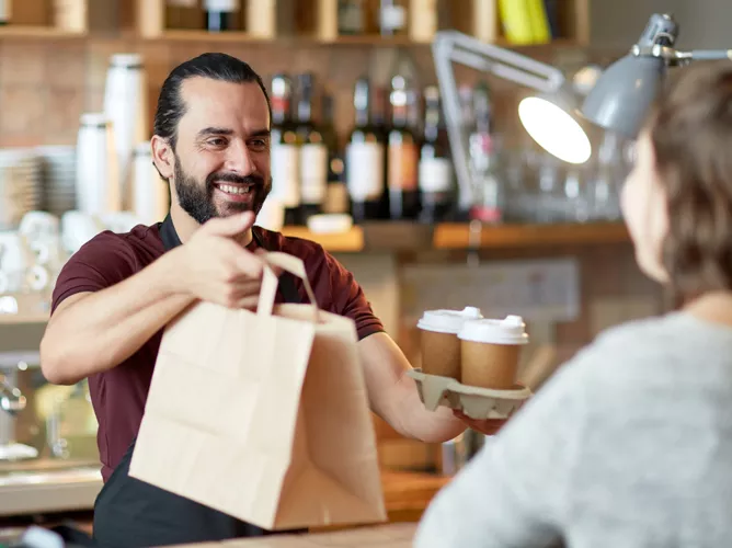 Man giving customer their coffee