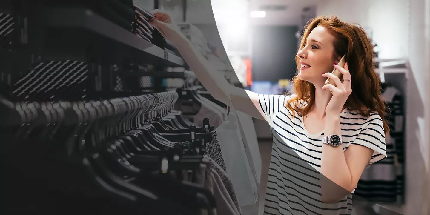 woman shopping in a retail store while on her mobile phone