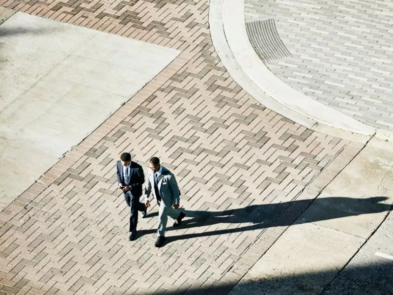 two men walking in courtyard