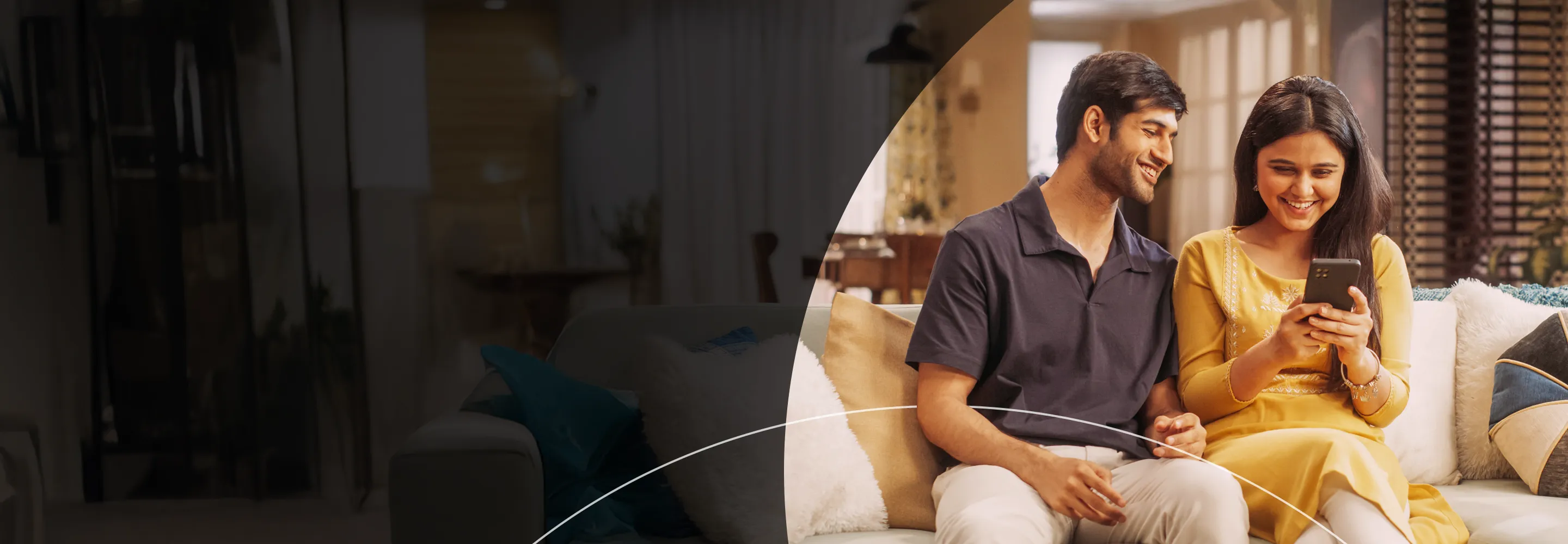 Indian couple on the couch looking at phone banner