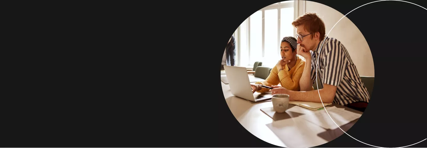 Man and woman working on computer banner