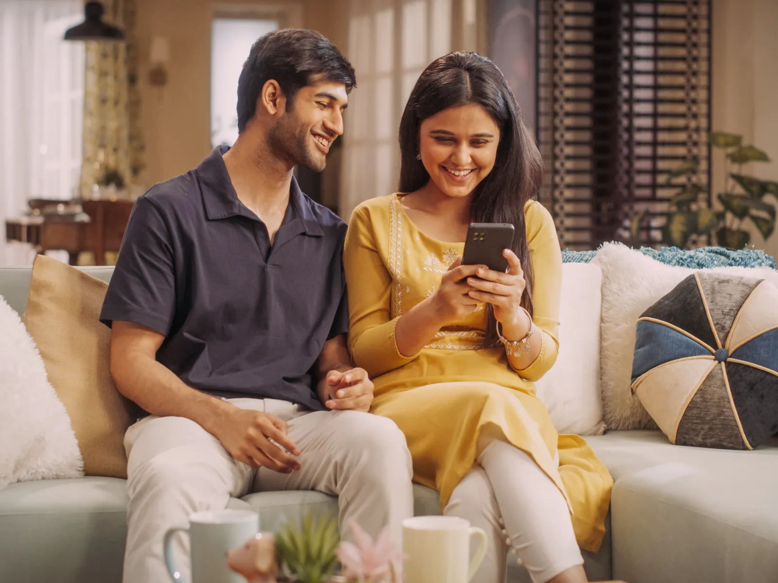 Man and wife smiling at phone
