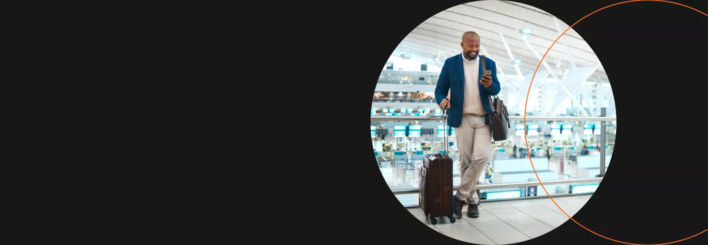 Image of male business traveler holding a suitcase at the airport