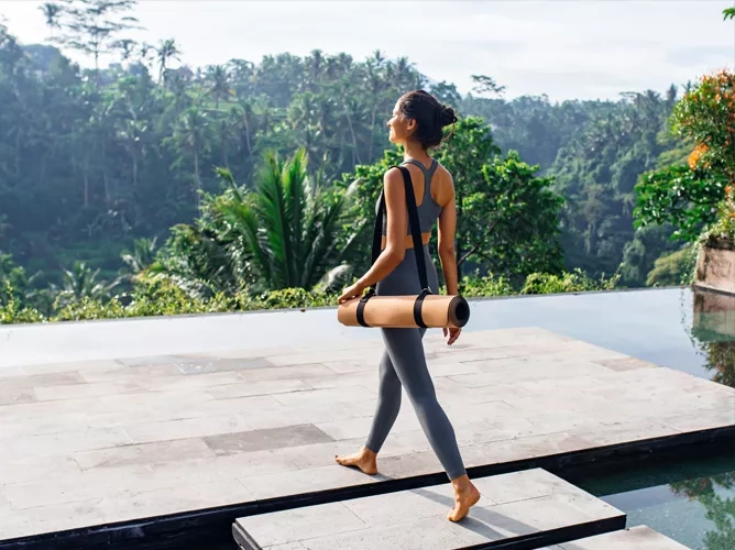 Woman with yoga mat teaser