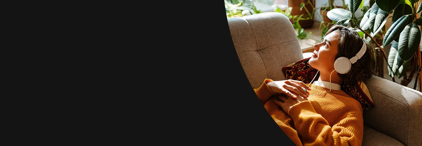 Woman looking out the window listening to headphones