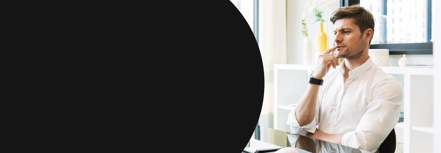 Man in front of computer pondering