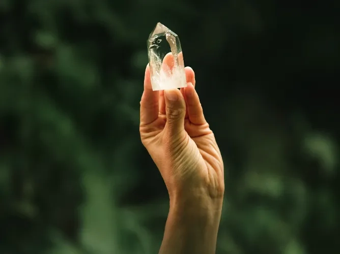 Hand holding crystal