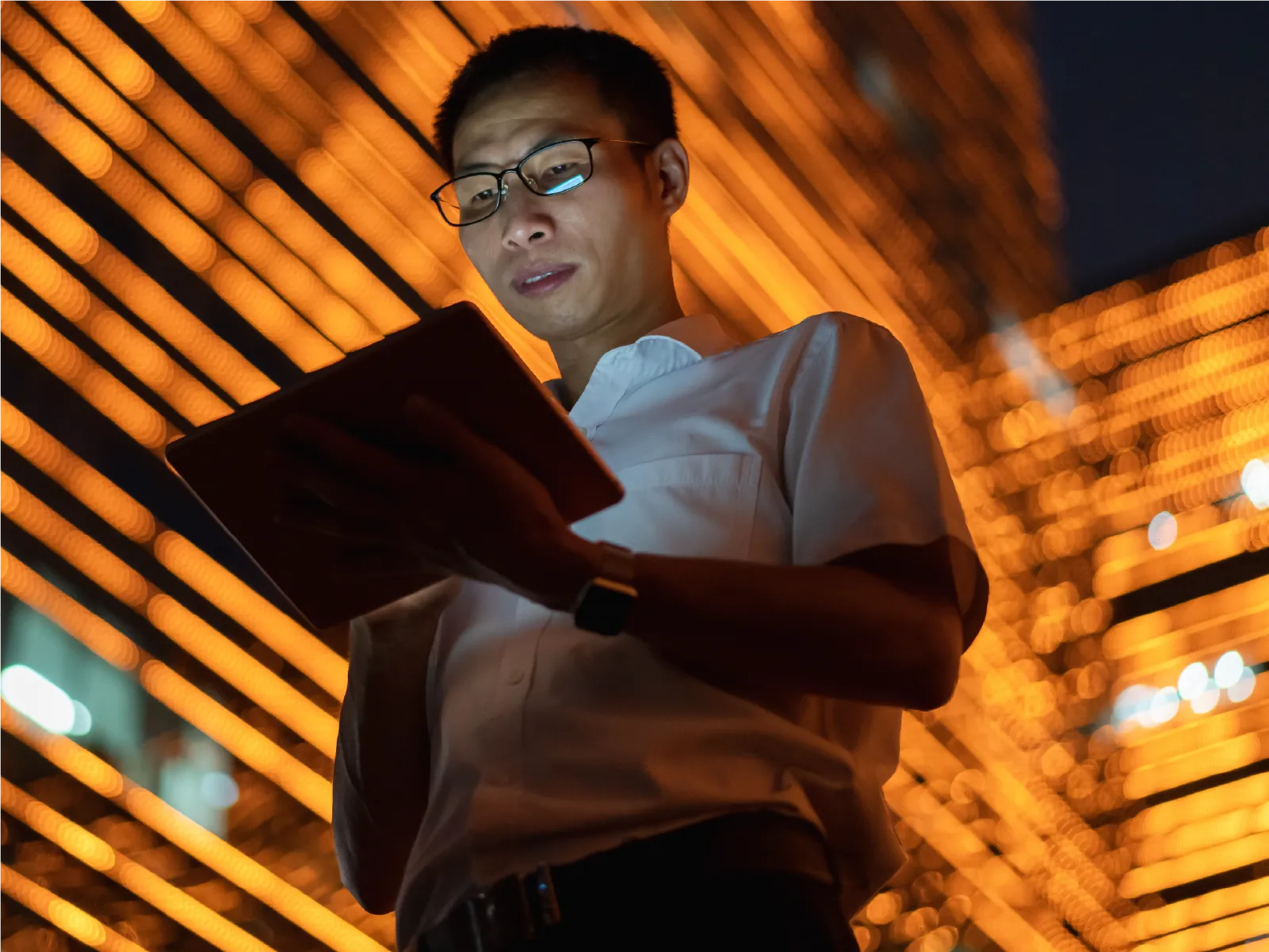 Man on tablet in front of orange backdrop